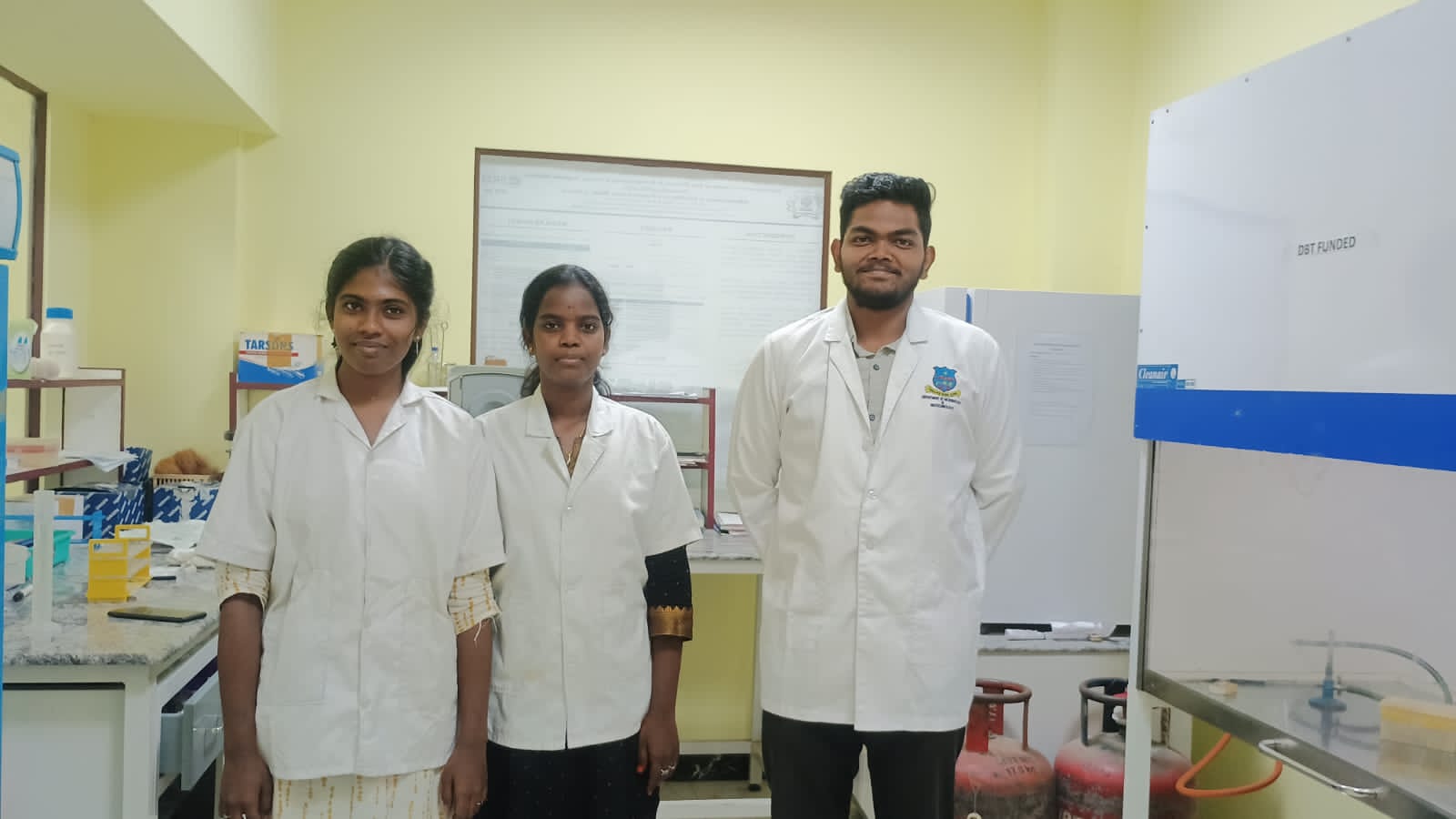 Students in lab coats working on experiments